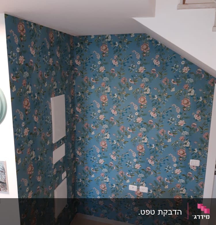 קיר עם טפט פרחוני צבעוני מתחת למדרגות